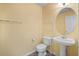 Half bathroom features neutral paint color and a pedestal sink at 1218 Matt Moore Ct, Lithia Springs, GA 30122