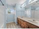 Bathroom features dual sinks, wood cabinets, and a large mirror at 1218 Matt Moore Ct, Lithia Springs, GA 30122