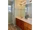 Bathroom vanity with double sinks and wooden cabinetry with decorative flower arrangement at 1218 Matt Moore Ct, Lithia Springs, GA 30122