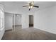 Bedroom with neutral carpet, ceiling fan, closet with mirror doors, flower wall decals, and a window at 1218 Matt Moore Ct, Lithia Springs, GA 30122