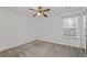 This bedroom features neutral carpet, a ceiling fan, natural light from the window, and mirrored closet doors at 1218 Matt Moore Ct, Lithia Springs, GA 30122