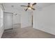 Bedroom with neutral carpet, ceiling fan, closet with mirror doors, and a door to another room at 1218 Matt Moore Ct, Lithia Springs, GA 30122