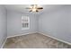 Bedroom with neutral carpeting features a ceiling fan and a window for natural light at 1218 Matt Moore Ct, Lithia Springs, GA 30122