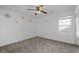 This bedroom features neutral carpet, a ceiling fan, natural light from the window, and flower wall decals at 1218 Matt Moore Ct, Lithia Springs, GA 30122