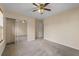 Bedroom with neutral carpet, ceiling fan, closet with mirror doors, a window and neutral paint at 1218 Matt Moore Ct, Lithia Springs, GA 30122
