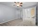 Bedroom with neutral carpeting features a ceiling fan and closet for storage at 1218 Matt Moore Ct, Lithia Springs, GA 30122