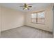This bedroom features neutral carpet, a ceiling fan, natural light from the window, and neutral paint at 1218 Matt Moore Ct, Lithia Springs, GA 30122