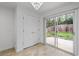 Bright dining area features modern chandelier, tile flooring, and sliding glass door to backyard at 1218 Matt Moore Ct, Lithia Springs, GA 30122