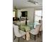 Elegant dining room with modern chandelier, glass table, and comfortable chairs at 1218 Matt Moore Ct, Lithia Springs, GA 30122