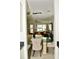 Stylish dining area with glass table, cozy chairs, and open view to the living room at 1218 Matt Moore Ct, Lithia Springs, GA 30122