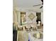 Dining area with chandelier, modern art, and glass table, adjacent to a cozy living space at 1218 Matt Moore Ct, Lithia Springs, GA 30122