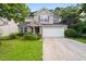 Well maintained two-story home with stone accents, manicured lawn, and an attached two car garage at 1218 Matt Moore Ct, Lithia Springs, GA 30122