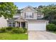 Charming two-story home with stone accents, a well-manicured lawn, and attached two car garage at 1218 Matt Moore Ct, Lithia Springs, GA 30122