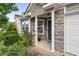 Cozy front porch with stone accents and decorative landscaping at 1218 Matt Moore Ct, Lithia Springs, GA 30122