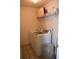 Functional laundry room with a washer, dryer, and overhead shelving at 1218 Matt Moore Ct, Lithia Springs, GA 30122