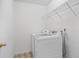 The laundry room includes a washer, dryer, storage shelving, and tile flooring at 1218 Matt Moore Ct, Lithia Springs, GA 30122