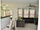 Comfortable living room with a gray sectional sofa, ceiling fan, and a sliding glass door to the backyard at 1218 Matt Moore Ct, Lithia Springs, GA 30122