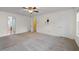 Main bedroom with neutral carpeting, ceiling fan, and doors leading to other areas at 1218 Matt Moore Ct, Lithia Springs, GA 30122