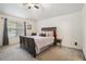 Cozy bedroom featuring neutral carpet, a ceiling fan, and natural light from a large window at 5527 Jerome Rd, College Park, GA 30349