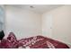Bedroom with neutral walls, a white door, and a comfortable-looking bed featuring a patterned comforter at 5527 Jerome Rd, College Park, GA 30349