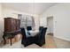 Dining room with a glass table, dark chairs, and a chandelier at 5527 Jerome Rd, College Park, GA 30349
