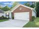 This home boasts an attached garage with a brick accent at 5527 Jerome Rd, College Park, GA 30349