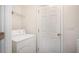 Clean laundry room with washer, dryer hookups, and shelving for organizing laundry essentials at 5527 Jerome Rd, College Park, GA 30349