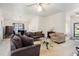 Comfortable living room with a fireplace and adjoined dining area with a chandelier at 5527 Jerome Rd, College Park, GA 30349
