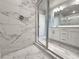 Modern walk-in shower in bathroom with stunning marble-like tiling and glass door at 1277 Fern Ridge Ct # 22, Norcross, GA 30093