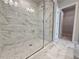 Luxurious bathroom featuring a modern walk-in shower with marble-like tiling and glass door at 1277 Fern Ridge Ct # 22, Norcross, GA 30093
