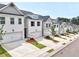 Row of townhomes featuring a two-car garage, neat landscaping, and a modern white brick facade at 1277 Fern Ridge Ct # 22, Norcross, GA 30093