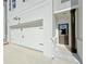 Modern townhome featuring a two-car garage, neat landscaping, and a white brick facade at 1277 Fern Ridge Ct # 22, Norcross, GA 30093