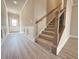 Welcoming foyer features hardwood floors, wainscoting, and a staircase at 1277 Fern Ridge Ct # 22, Norcross, GA 30093