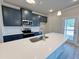 Modern kitchen featuring a large island, quartz countertops, and stainless appliances at 1277 Fern Ridge Ct # 22, Norcross, GA 30093