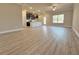 Open-concept living room with wood-look flooring and a view of the kitchen at 1277 Fern Ridge Ct # 22, Norcross, GA 30093