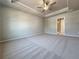 Expansive main bedroom features a tray ceiling, soft carpeting and a connected bathroom at 1277 Fern Ridge Ct # 22, Norcross, GA 30093