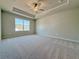 Large carpeted main bedroom featuring a tray ceiling, fan, and natural lighting at 1277 Fern Ridge Ct # 22, Norcross, GA 30093