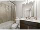 Well-lit bathroom featuring shower-tub combo with a dark vanity and white countertop at 1358 Pavilion Se Ct, Atlanta, GA 30316