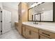 Well-lit bathroom with double vanity, wood cabinets, large mirror, and modern fixtures, combining style and functionality at 1358 Pavilion Se Ct, Atlanta, GA 30316