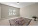 Neutral bedroom featuring large window, decorative rug, and great natural light at 1358 Pavilion Se Ct, Atlanta, GA 30316