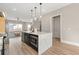 Open-concept kitchen with modern island, stainless steel appliances, and seamless transition to the adjacent living area at 1358 Pavilion Se Ct, Atlanta, GA 30316