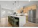 A modern kitchen featuring a waterfall island, pendant lights, stainless steel appliances, and sleek wooden cabinets at 1358 Pavilion Se Ct, Atlanta, GA 30316