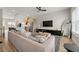 Open-concept living room flowing into the kitchen with stainless steel appliances and a modern island at 1358 Pavilion Se Ct, Atlanta, GA 30316