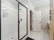 Stylish walk-in shower with glass enclosure, white tile, and built-in niche, adjacent to a well-appointed bathroom at 1358 Pavilion Se Ct, Atlanta, GA 30316