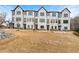 Beautiful new row of townhomes showcasing a modern black and white exterior design on a well-manicured lawn at 1358 Pavilion Se Ct, Atlanta, GA 30316