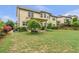 Lush backyard featuring a covered patio and a mix of mature trees and flowering shrubs at 1645 Colleens Cask Ter, Dacula, GA 30019