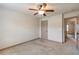 Simple bedroom with neutral walls, carpet flooring, ceiling fan, and closet at 1645 Colleens Cask Ter, Dacula, GA 30019