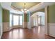 Dining room featuring hardwood floors, elegant lighting, and wainscoting detail at 1645 Colleens Cask Ter, Dacula, GA 30019