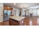 Modern kitchen with granite island is open to the living room and features stainless steel appliances at 1645 Colleens Cask Ter, Dacula, GA 30019