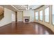 Spacious living room with hardwood floors, a cozy fireplace, and large windows at 1645 Colleens Cask Ter, Dacula, GA 30019